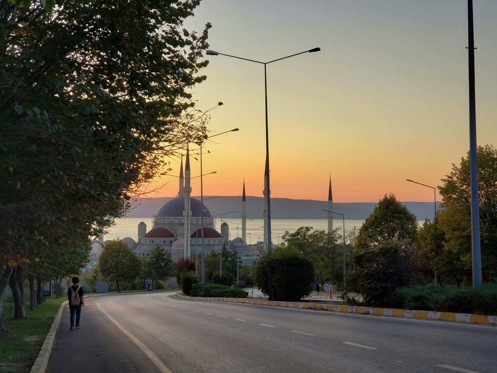 a couple of people walking down a street