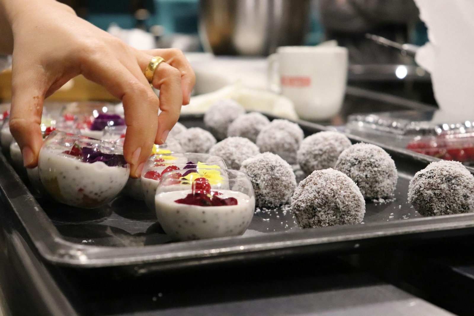 person picking dessert from tray